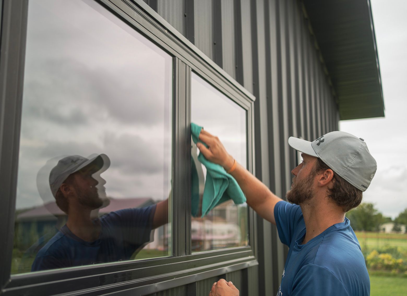 worker cleaning windows